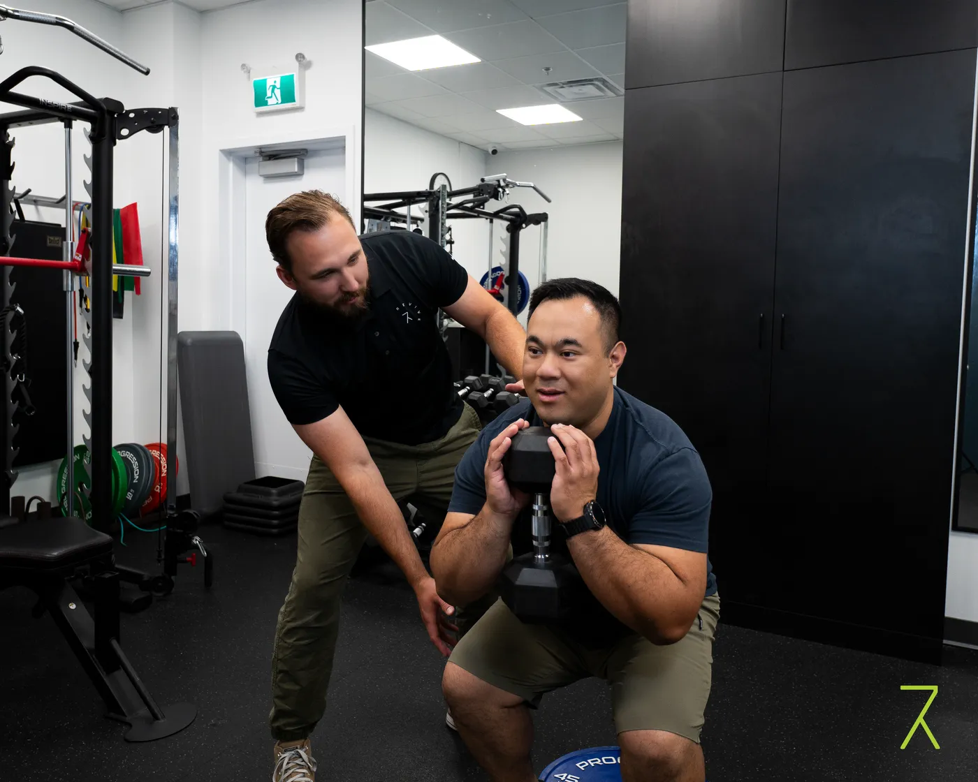 Kinesiologist guiding a patient through active rehab exercise at Revive Rehab