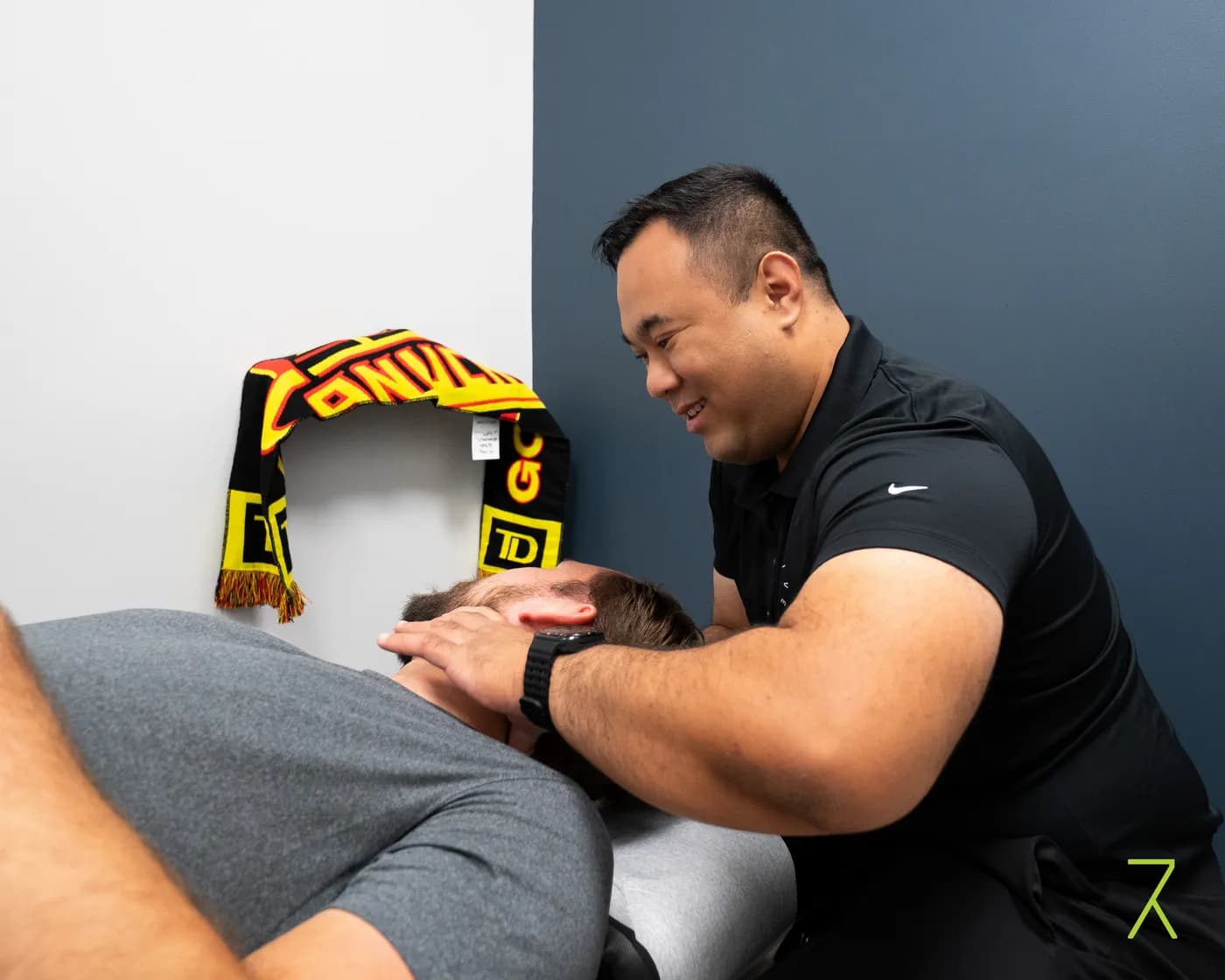 Chiropractor performing a cervical spinal adjustment at Revive Rehab